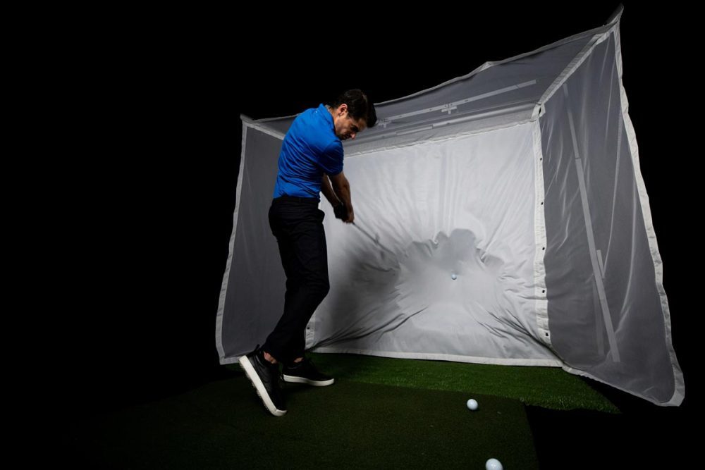 hitting a golf ball on the homecourse retractable ballistic grade screen material